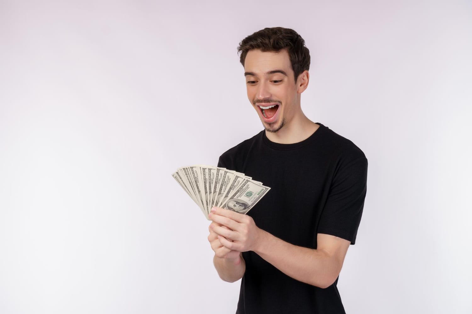 A man looking at his money notes and wondering if he should spend it on credit repair or not
