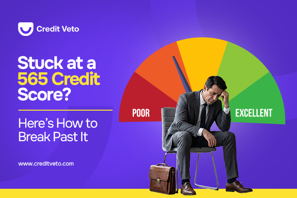 A man in suit seated with his head down in shame over his 565 credit score